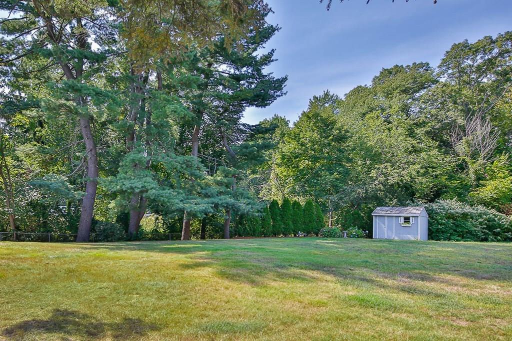 10 Ross Road Lexington, MA 02421 - Photo 4 of 36 a front view of a house with a yard and trees