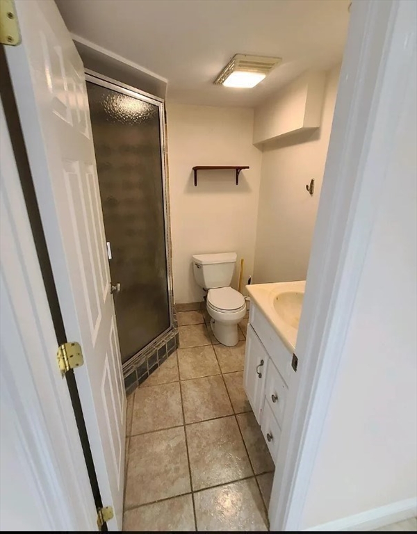1 Hilltop Road, Unit B Watertown, MA 02472 - Photo 4 of 5 a bathroom with a granite countertop shower and a toilet