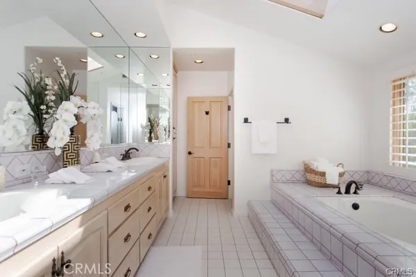 a spacious bathroom with a double vanity sink mirror and shower