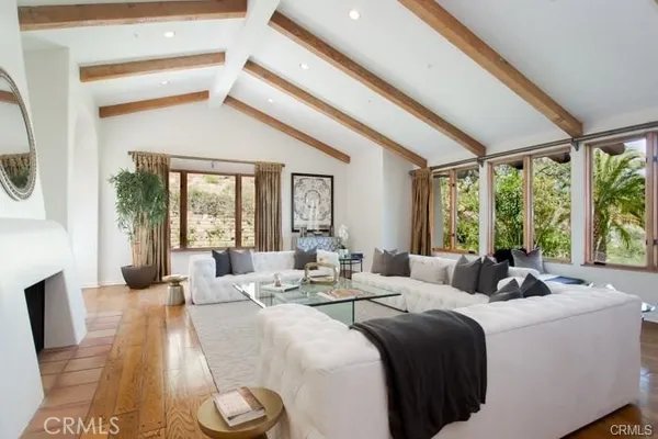 a bedroom with two beds and large windows
