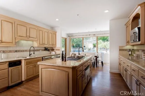 a kitchen with a sink stove and cabinets