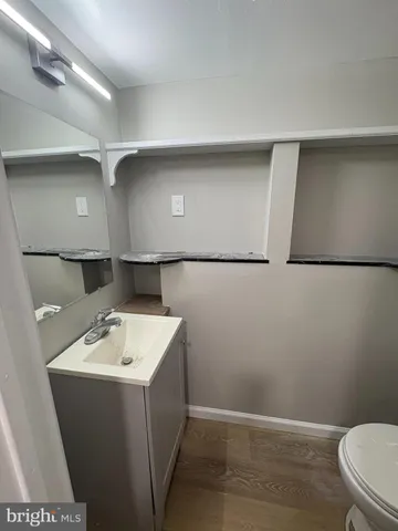 a bathroom with a sink a toilet and vanity