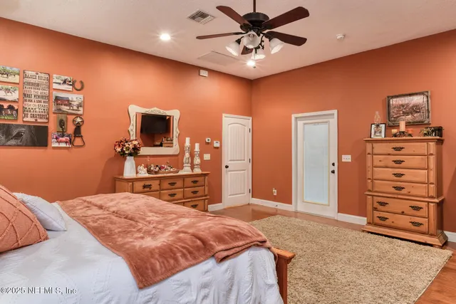 a view of a hallway with a dining table and chairs
