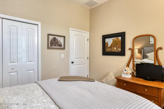 a bathroom with a granite countertop toilet a sink and a mirror
