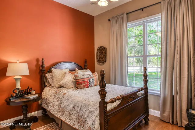 a bed room with a bed and a chair