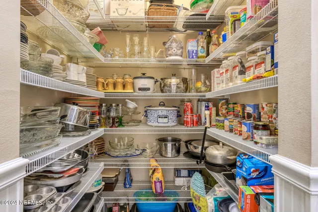 a sign that is sitting in the grass with trees