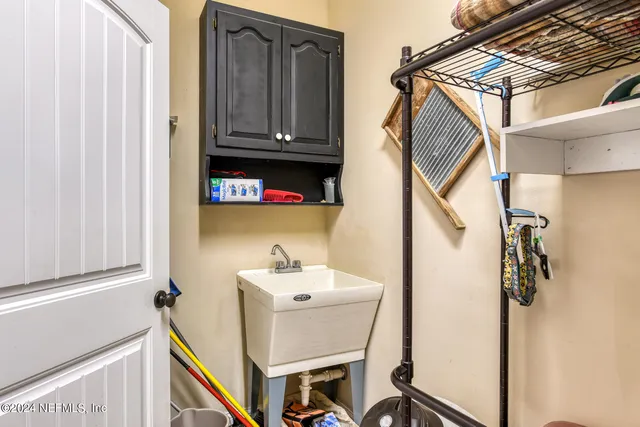 a view of a house with a yard and large trees