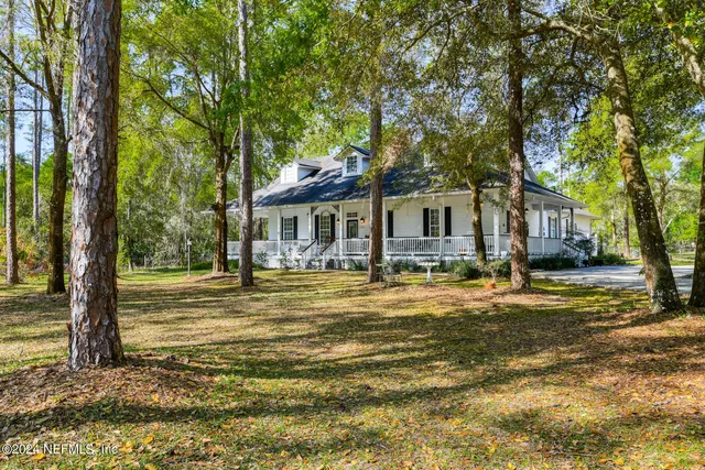 a front view of house with yard and trees