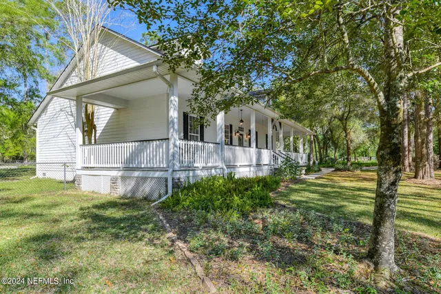 a view of a city from a balcony with furniture