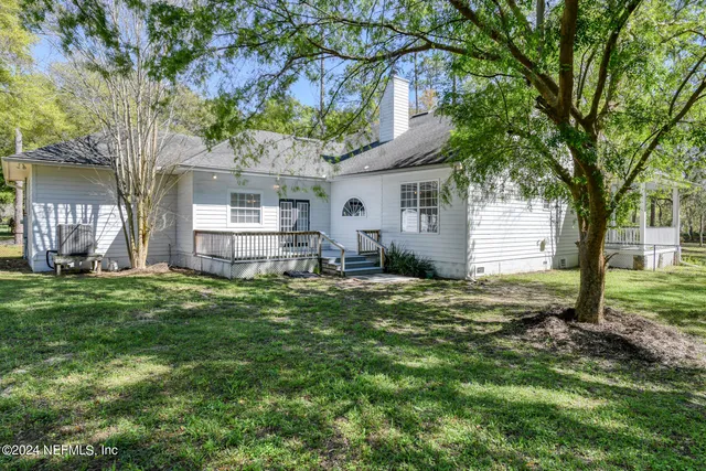 a view of a house with a yard patio and fire pit