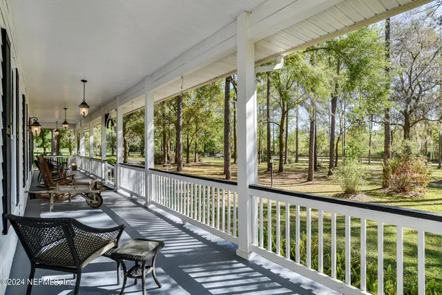 a view of a chairs and table in patio with wooden floor