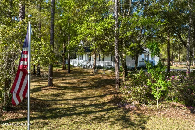 a backyard of a house with table and chairs