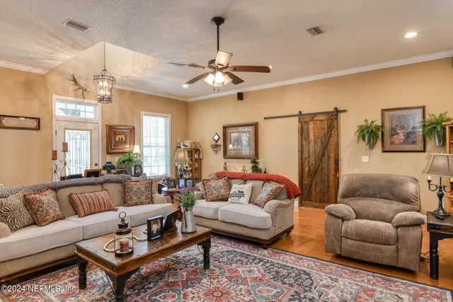 a living room with fireplace furniture and a chandelier