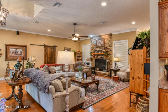 a living room with fireplace furniture and a chandelier