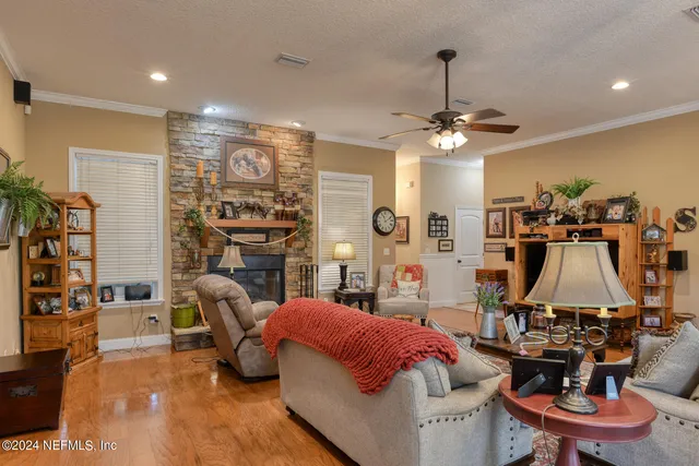 a living room with furniture a flat screen tv and a fireplace