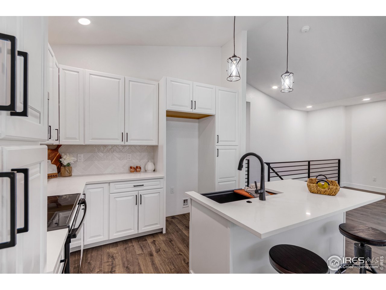 1230 Swainson Road Eaton, CO 80615 - Photo 15 of 29 a kitchen with a sink a stove and cabinets