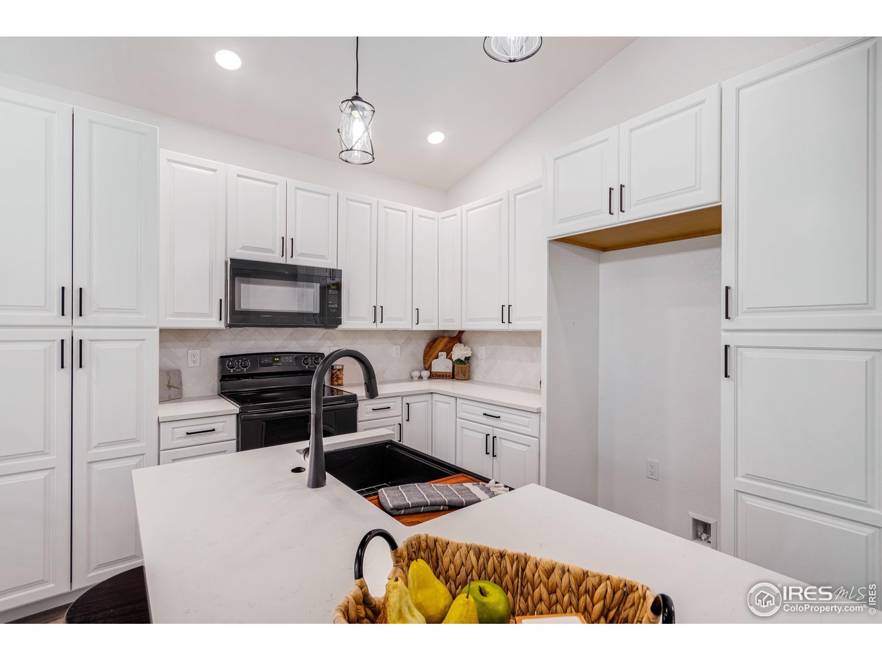1230 Swainson Road Eaton, CO 80615 - Photo 16 of 29 a kitchen with stainless steel appliances a stove a sink and white cabinets