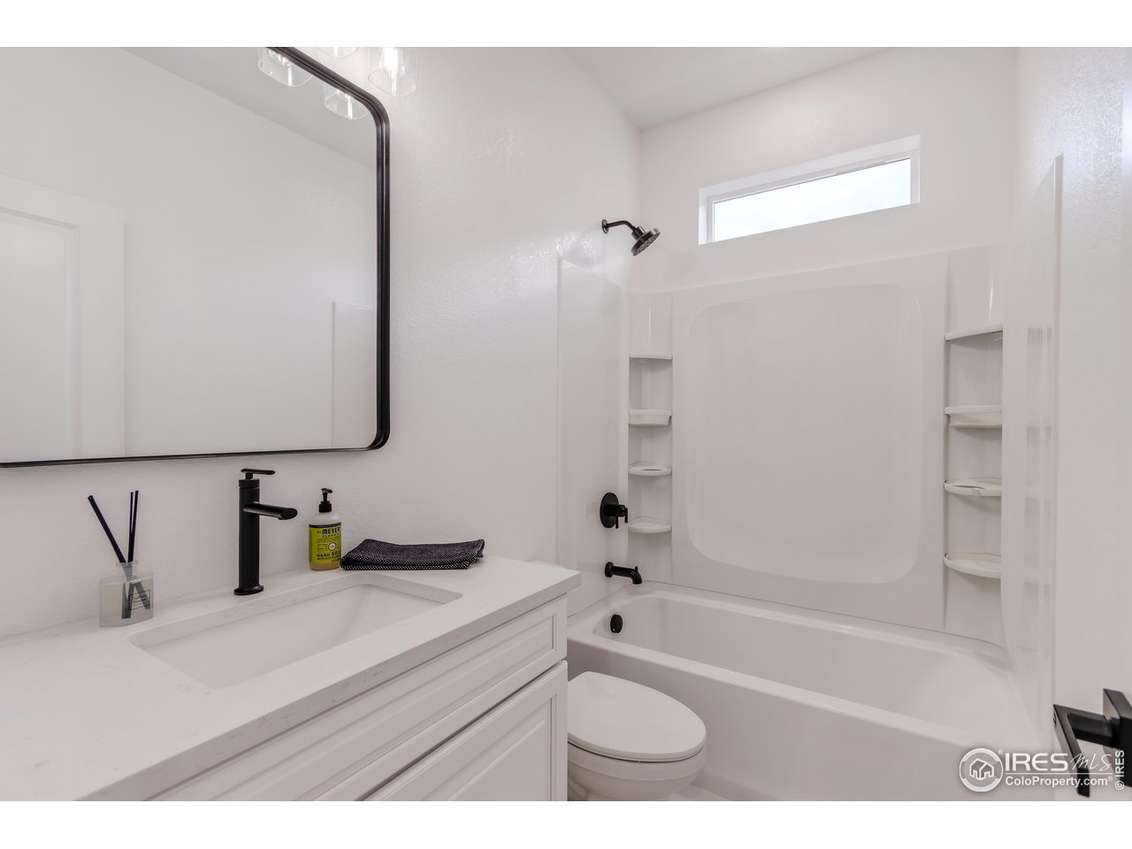1230 Swainson Road Eaton, CO 80615 - Photo 20 of 29 a bathroom with a bathtub sink vanity and mirror