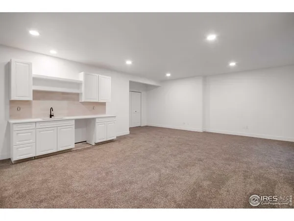 a view of a kitchen with white cabinets
