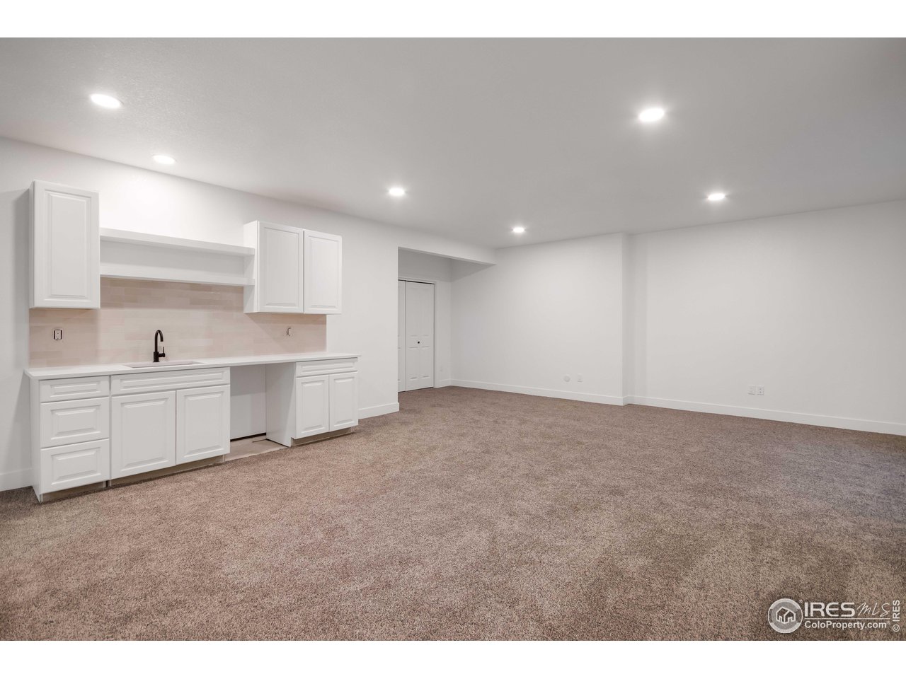 1230 Swainson Road Eaton, CO 80615 - Photo 25 of 29 a view of a kitchen with white cabinets