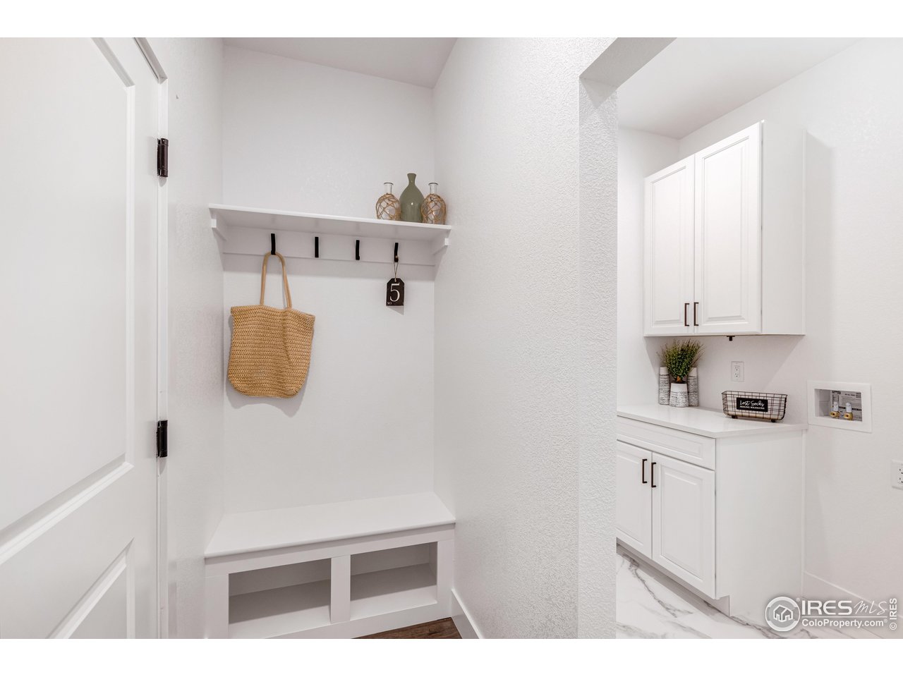 1230 Swainson Road Eaton, CO 80615 - Photo 6 of 29 a kitchen with a refrigerator and white cabinets