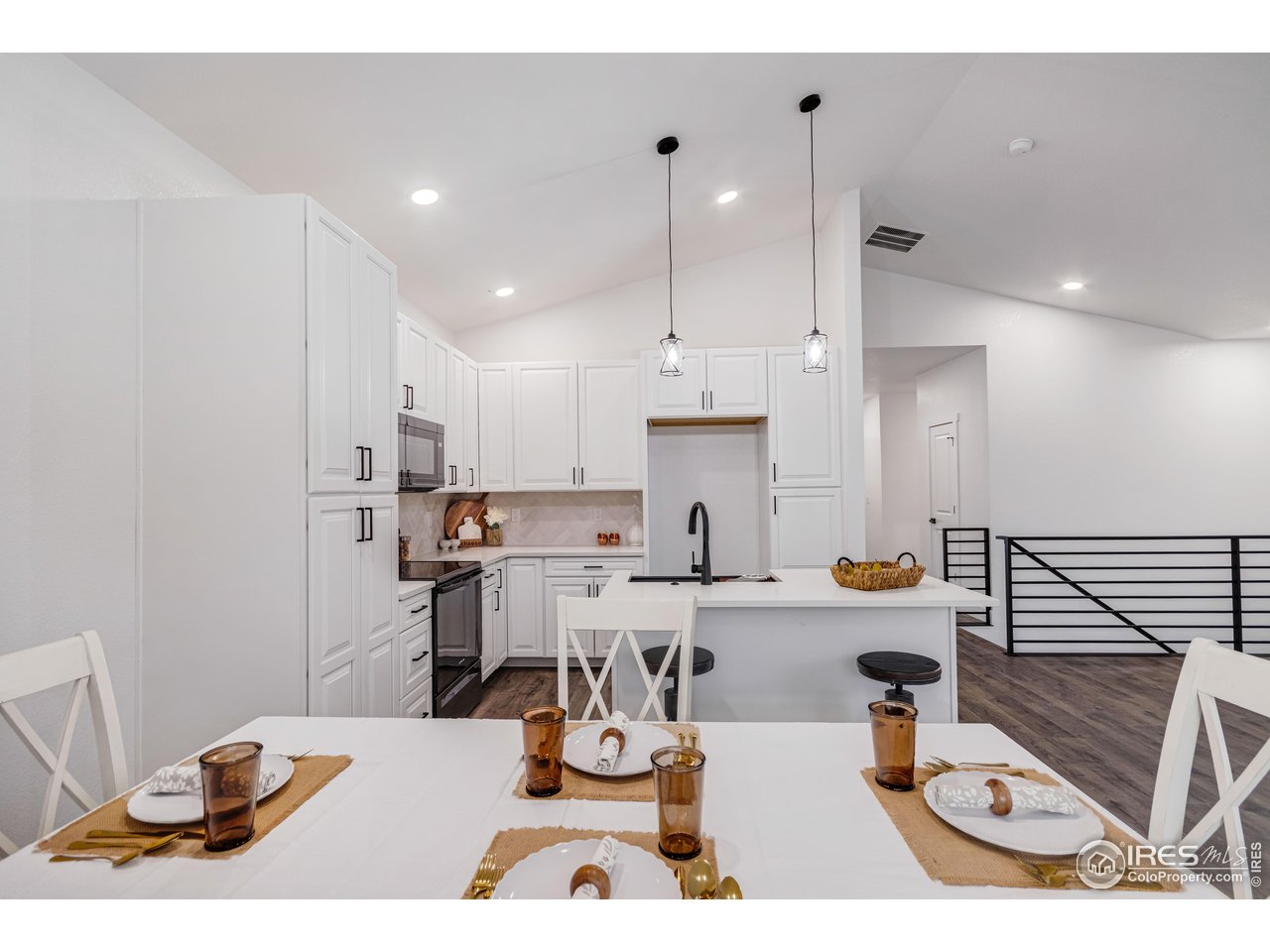 1230 Swainson Road Eaton, CO 80615 - Photo 8 of 29 a kitchen with stainless steel appliances kitchen island granite countertop a sink and cabinets