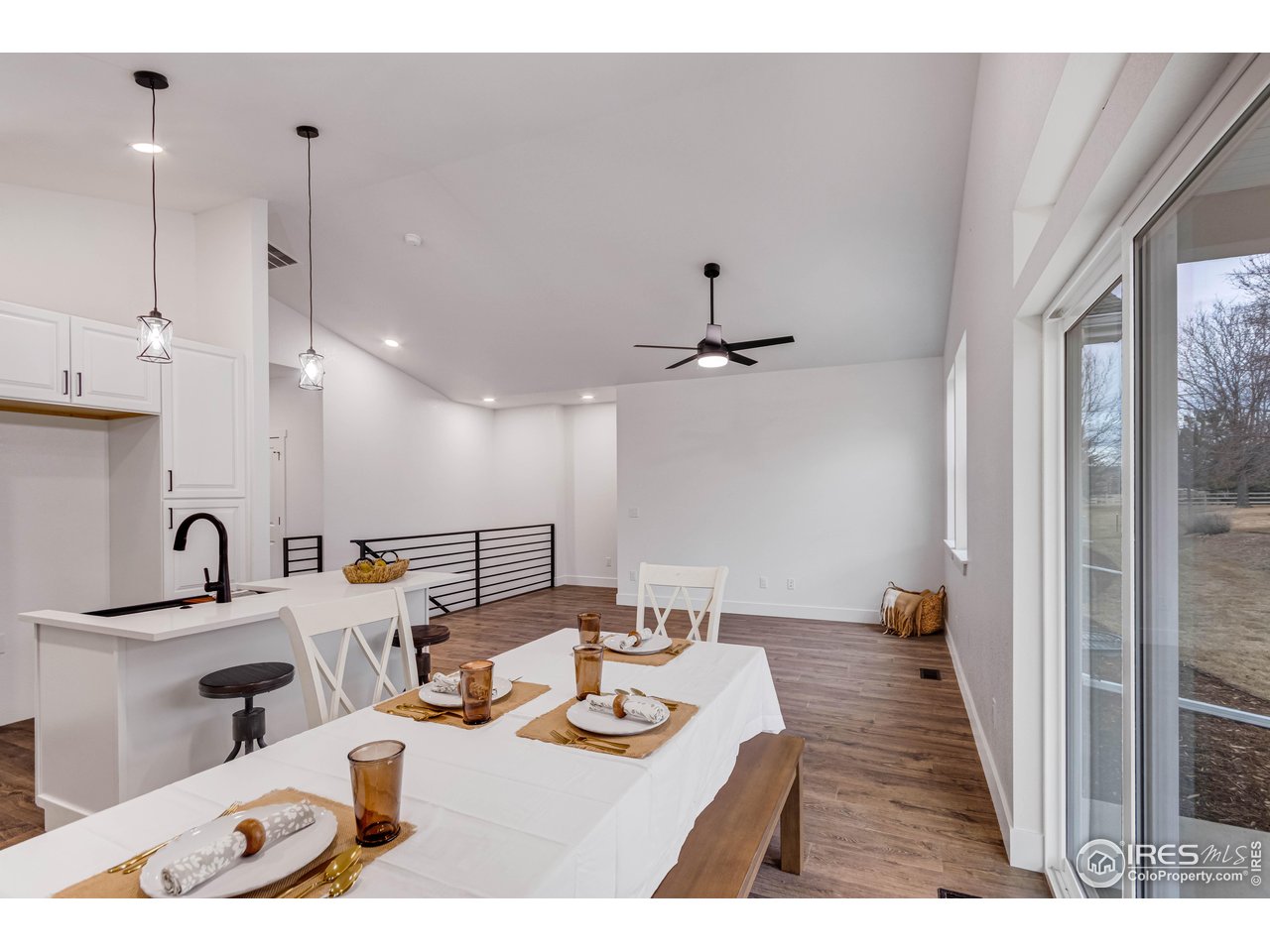 1230 Swainson Road Eaton, CO 80615 - Photo 10 of 29 a open kitchen with stainless steel appliances kitchen island granite countertop a sink and a refrigerator