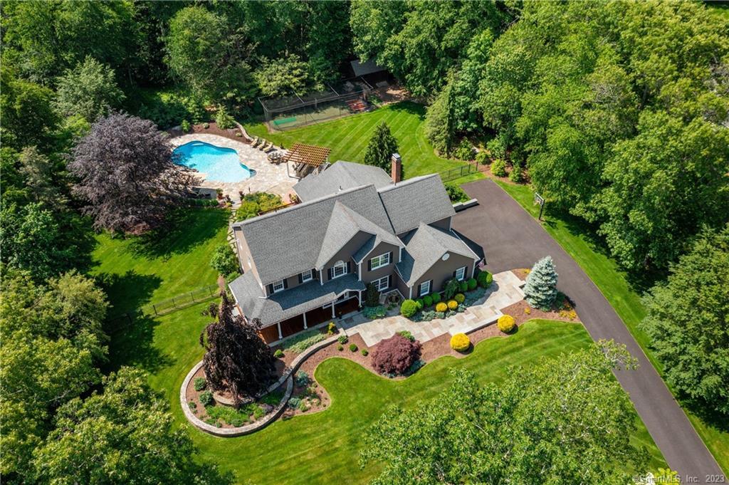an aerial view of a house with yard swimming pool and outdoor seating