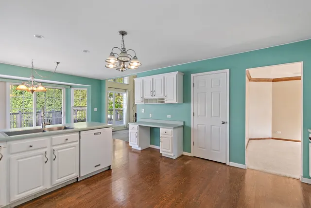 a room with wooden floors and white walls