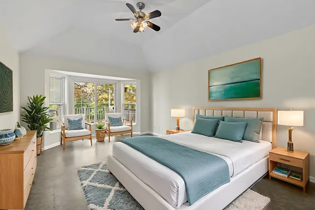 a bedroom with furniture and a window