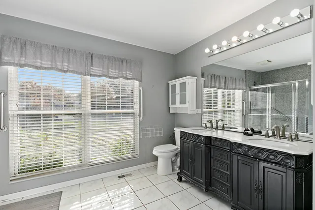 a bathroom with a sink double vanity and a shower