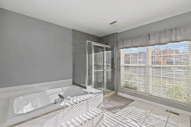 a view of a livingroom with wooden floor and bathroom