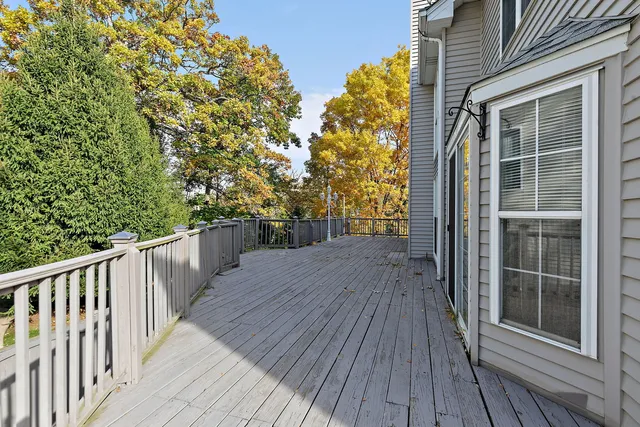 a view of balcony with wooden floor and fence