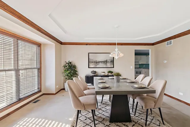 a dining room with furniture and window
