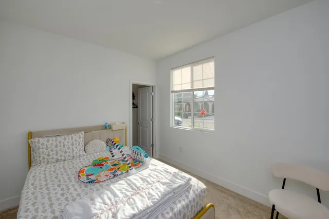 a bedroom with a bed and a couch