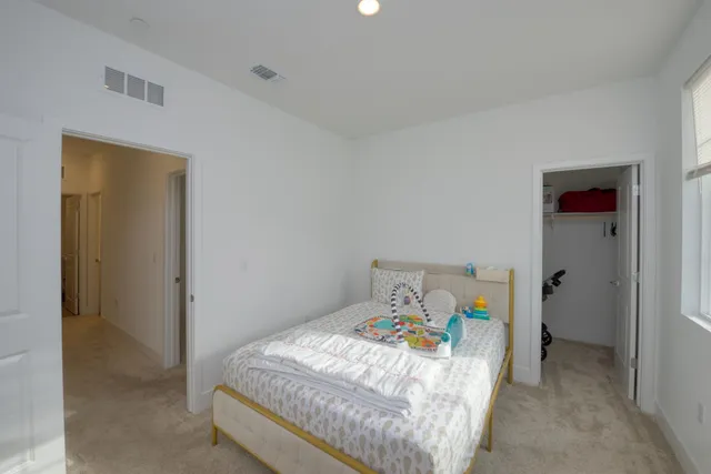 a bedroom with a bed and a cabinets