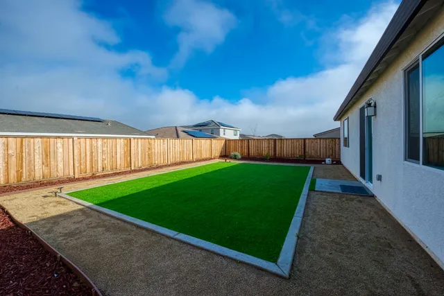 a view of a backyard with grass