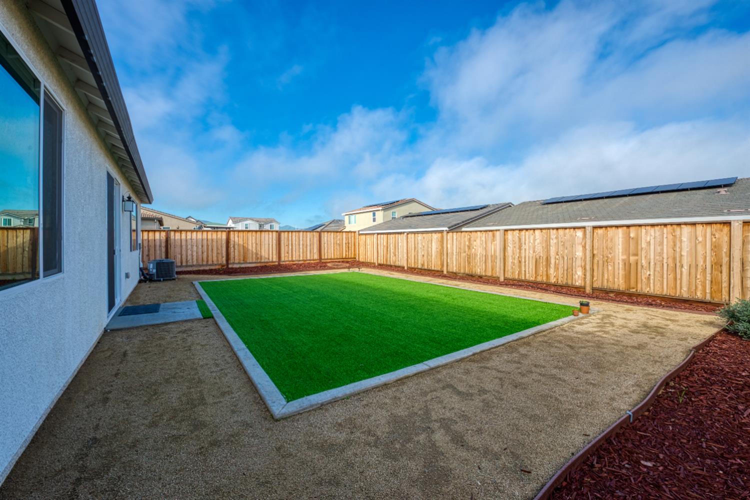 2209 Greenhorn Road Patterson, CA 95363 - Photo 26 of 32 a view of a backyard with brick wall and large window