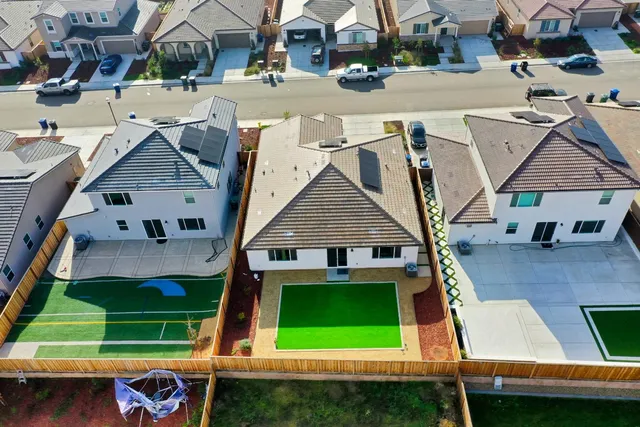an aerial view of a house with a yard
