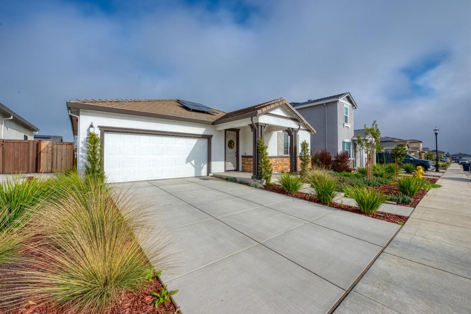 2209 Greenhorn Road Patterson, CA 95363 - Photo 5 of 32 a front view of a house with a yard and potted plants