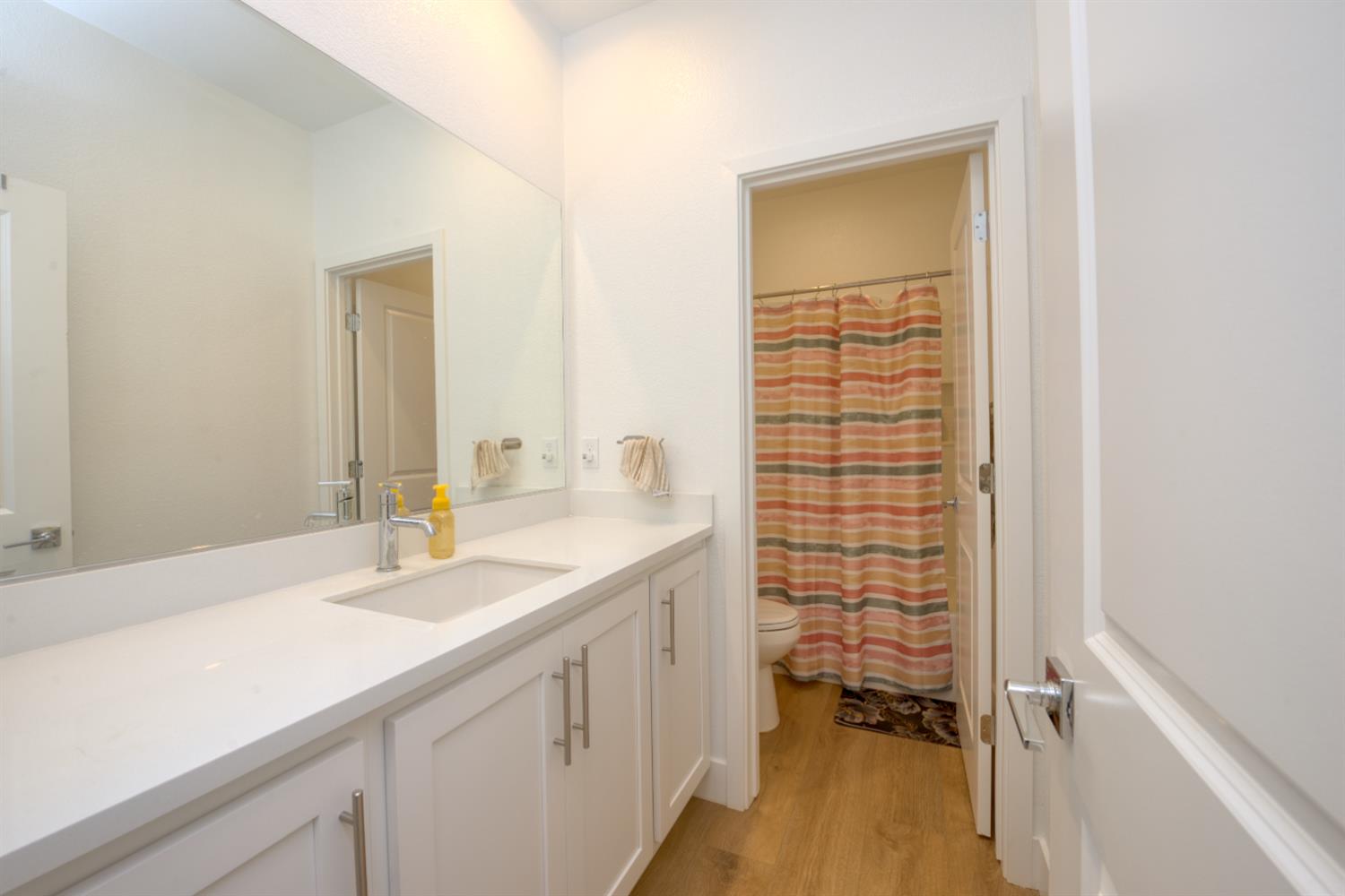 2209 Greenhorn Road Patterson, CA 95363 - Photo 7 of 32 a bathroom with a sink a vanity and a mirror