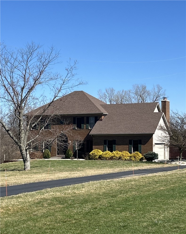 10160 Lochard Road Sidney, OH 45365 - Photo 1 of 41 This brick residence offers a spacious driveway, attached garage, and manicured landscaping.