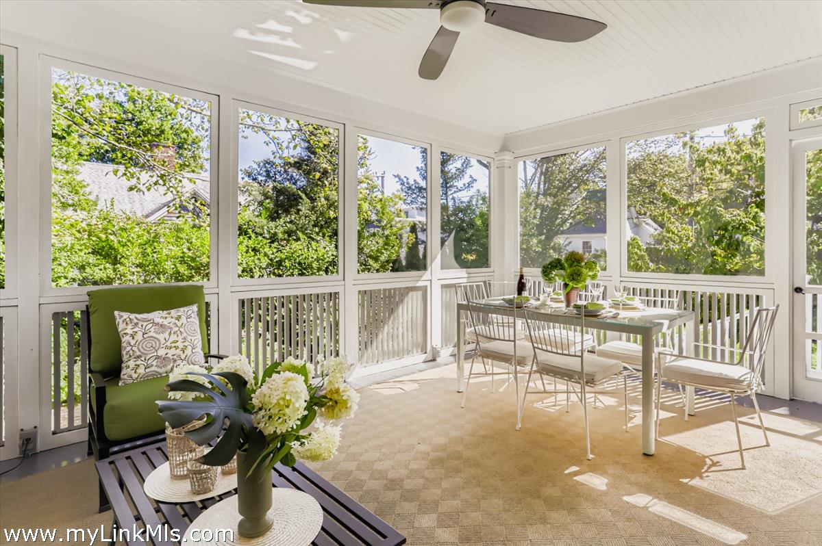 27 Spring Street Vineyard Haven, MA 02568 - Photo 7 of 58 a dining room with furniture water view and a floor to ceiling window