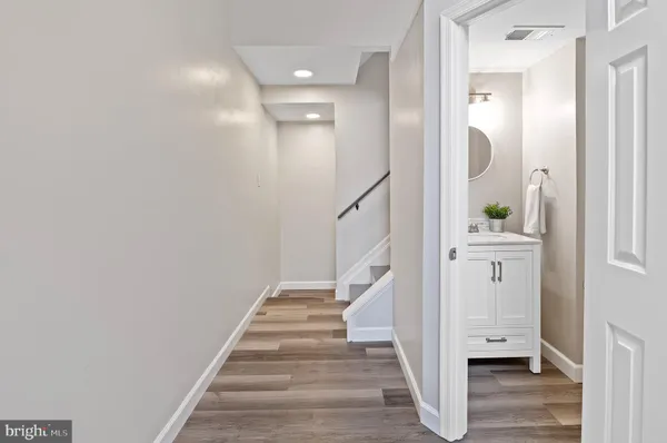 a view of a hallway with wooden floor and entryway