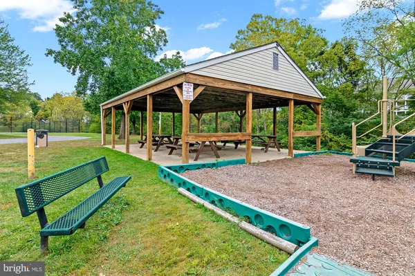 a view of an house with backyard and sitting area