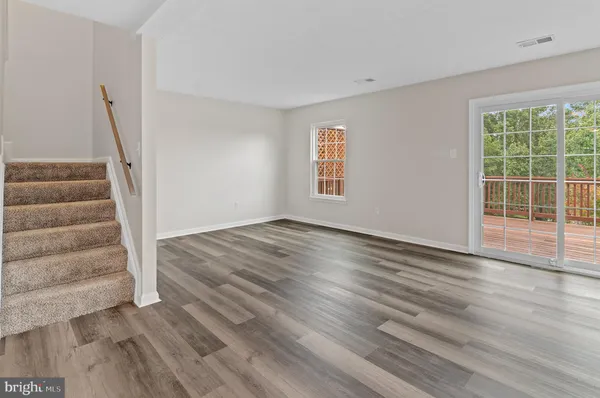 a view of wooden floor and windows in a room