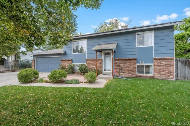 a front view of a house with yard and garage