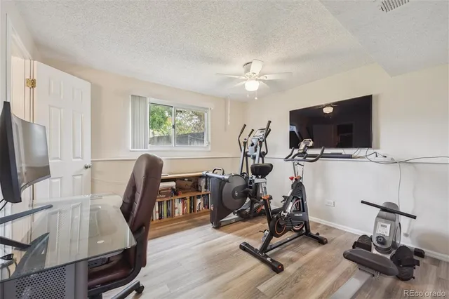 a view of a workspace with furniture and a flat screen tv
