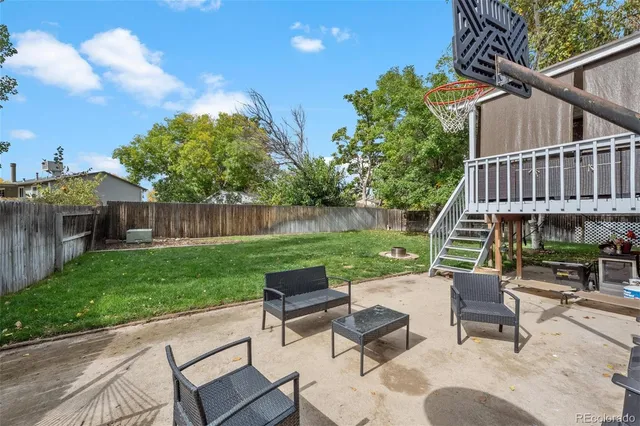 a view of a patio with a table and chairs
