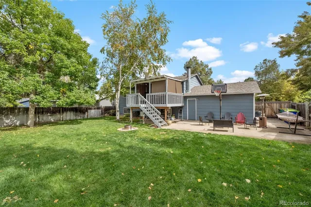 a view of a house with a backyard and a patio